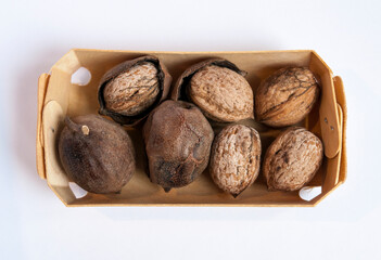 Top view of box with inshell walnuts and skins