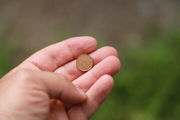 Coin one cent of Canada in hand