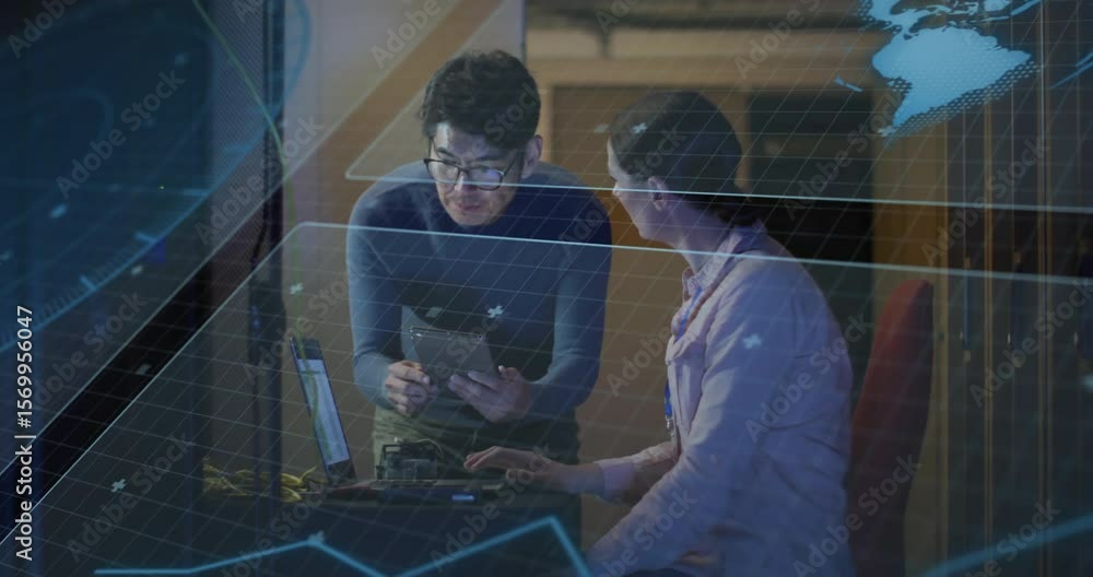 Poster man holding tablet in research workspace pointing at data while woman typing under floating grids