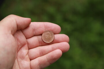Coin of Great Britain in hand