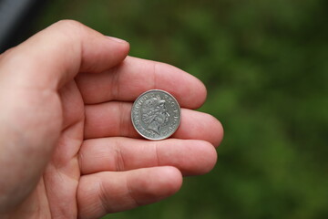 Coin of Great Britain in hand
