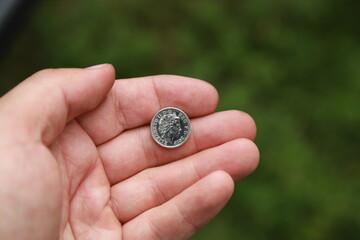 Coin of Great Britain in hand