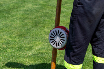 Firefighter in protective uniform holding a handheld fire alarm siren – equipment used during...