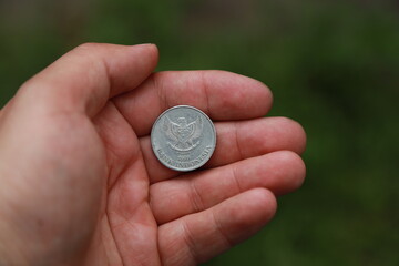 Indonesian change coin in hand