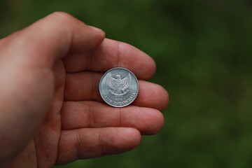Indonesian change coin in hand