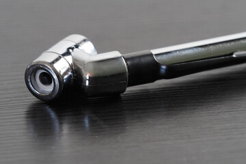 Tool for wheel pressure measurements with a chrome finish. Close-up. 
