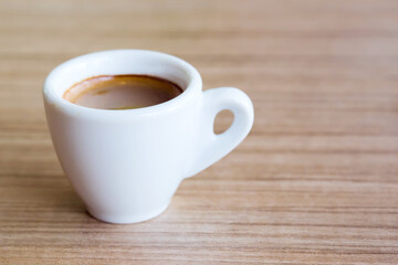 Cup of espresso coffee with coffee beans on the table, Artistic selective focus