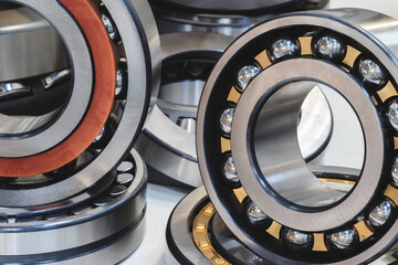 Collection of different sized and colored ball bearings. Some are gold and some are silver. The...
