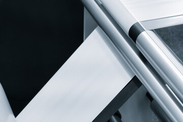 A machine with a roll of polyethylene plastic wrapping film on it. The machine is in a factory....