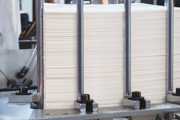 Elements of corton boxes are collected in stack. Conveyor line for the production of boxes. Machine...