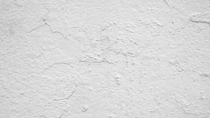 White wall with a rough texture. The wall is covered in white paint. The wall is not very smooth.
