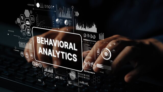 Hands typing on keyboard with overlay of behavioral analytics data visualization and graphs in a digital environment. Asymptotic smart data analytic.