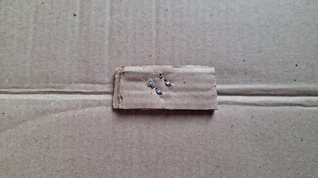 Metal staple on brown cardboard