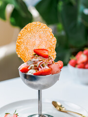 Fraise Melba ice cream. Creamy strawberry ice cream with fresh strawberries decorated with cookies...