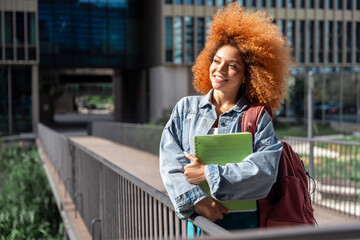 Brazilian redhead student ready for educational course, looking at copy space. Dreaming African...