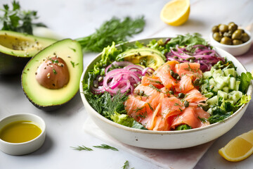 Creative food template. Avocado, Smoked Salmon Keto Salad on mixed greens with onion, capers, fresh dill vegetable, lemon wedge, olive oil, herbs, ground pepper on white marble top. copy text space. 
