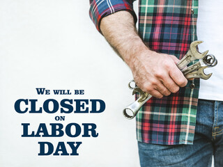 Signboard with the inscription We will be closed on Labor Day. Congratulations for family, loved...
