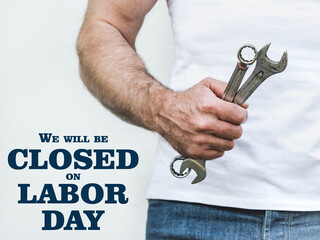Signboard with the inscription We will be closed on Labor Day. Congratulations for family, loved...