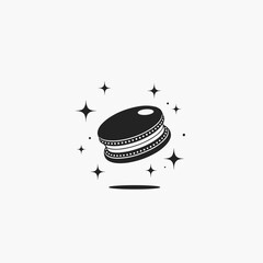Black macaron with sparkle stars around in minimal style - dessert and elegance concept