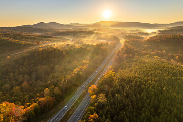 American highway in North Carolina Appalachian mountains in fall season with fast moving traffic. Interstate transportation concept