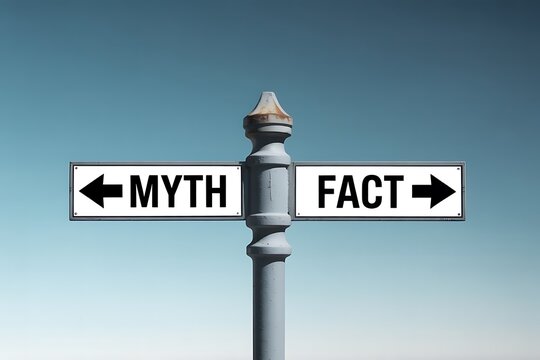 A conceptual image of a street signpost with two signs pointing in opposite directions one indicating myth and the other fact