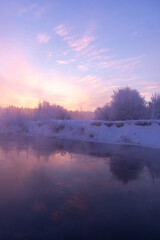 Fototapeta premium Dawn on a frosty morning on the river in winter