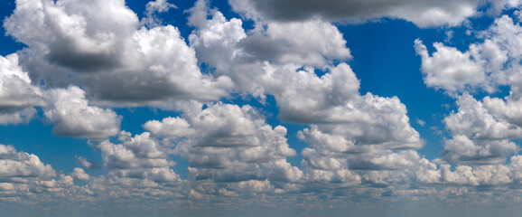Blue sky with white summer rain clouds. Colorful summer landscape