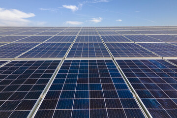Office building with solar roof. Blue photovoltaic panels for producing clean ecological electric...