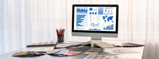 Interior designer workspace table and architecture software on laptop screen with mood board...