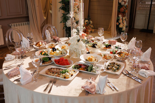 beautiful decorated banquet table in restaurant with variety of food