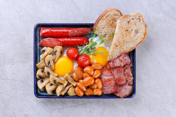 Full English Breakfast with Eggs Sausage Bacon Mushrooms and Beans