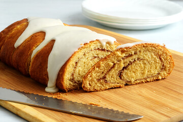 closeup of cinnamon roll loaf cake with icing sugar