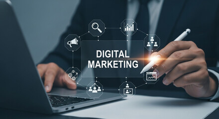 A man using a laptop with a digital marketing graphic overlay and a pen in his hand on a desk