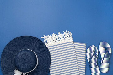 Blue beach accessories on color background, top view. Copy space for text