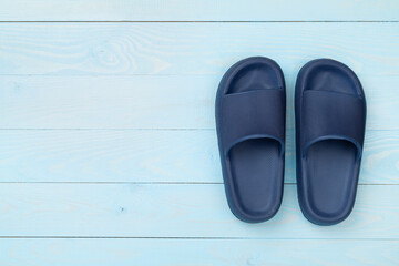 Blue sandals on wooden background,top view