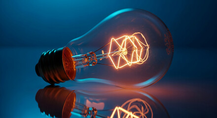 Glowing vintage lightbulb on reflective surface, showcasing warm filament detail against cool blue background, symbolizing ideas, innovation, and inspiration