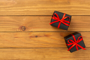 Black gift boxes on wooden background, top view. Black Friday concept