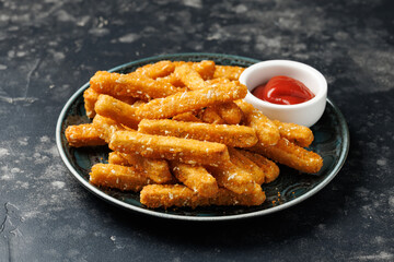 Potato rosti sticks with crispy coating in a plate
