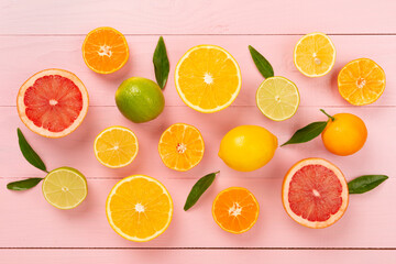 Different citrus fruits on wooden background, top view