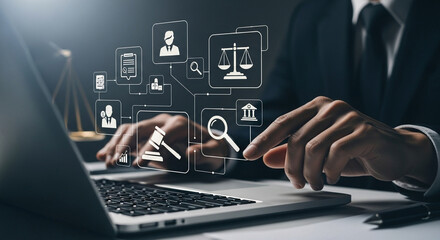 Fototapeta premium Man using laptop with legal icons hovering, scales of justice and gavel in the background scene view