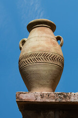 clay jar with the blue sky in the background