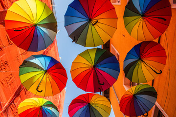 A Madrid street decorated with rainbow umbrellas for gay pride celebrations.
