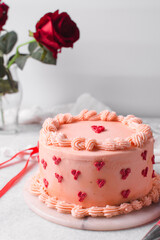 Pink buttercream cake on a cake plate, Cake covered in buttercream hearts