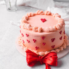 Pink buttercream cake on a cake plate, Cake covered in buttercream hearts