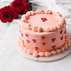 Pink buttercream cake on a cake plate, Cake covered in buttercream hearts