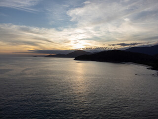 sunset behind the mountains on the beach
