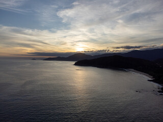 sunset behind the mountains on the beach