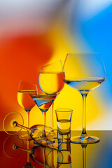 Glass goblets on a colored gradient background