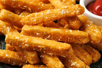 Potato rosti sticks with crispy coating in a plate