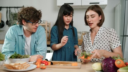 Happy father move to music while cooking food and prepare lunch at modern kitchen. Active dad...